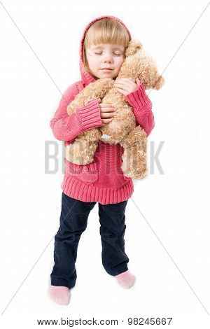 A Little Girl Hugging A Teddy Bear