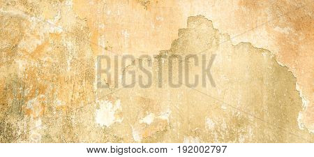 Old vintage grungy plaster beige painted wall texture background