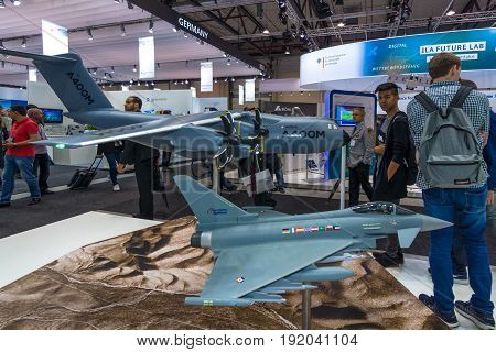 BERLIN GERMANY - JUNE 01 2016: The stand of Airbus Group. Models of military transport aircraft Airbus A400M Atlas and multirole fighter Eurofighter Typhoon. Exhibition ILA Berlin Air Show 2016.