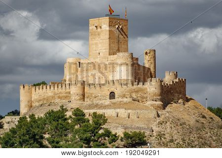 Top of the hill with Biar castle in Alicante with dark clouds, Spain