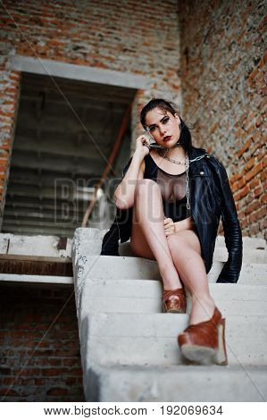 Brunette Plus Size Sexy Woman, Wear At Black One Piece And Leather Jacket,with Chain At Abadoned Pla