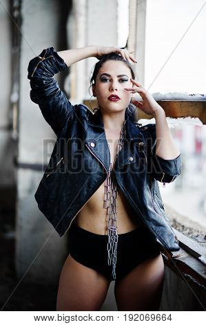 Brunette Plus Size Sexy Woman, Wear At Black Leather Jacket, Lace Panties And Chain At Abadoned Plac