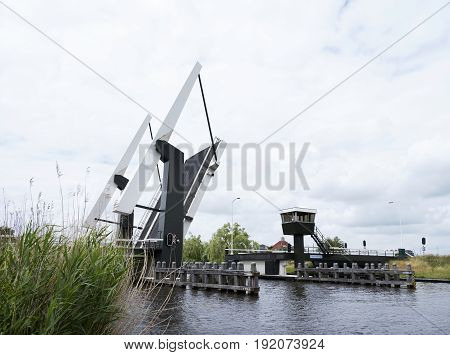 open modern drawbridge near Sneek in dutch province of friesland on overcast day in early summer