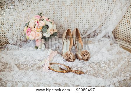 Luxury shoes and bride jewel mirror on the sofa