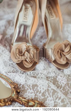 Luxury shoes and bride jewel mirror on the sofa