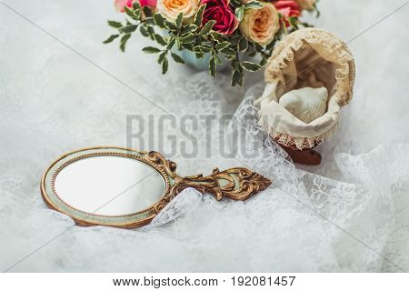 Luxury shoes and bride jewel mirror on the sofa