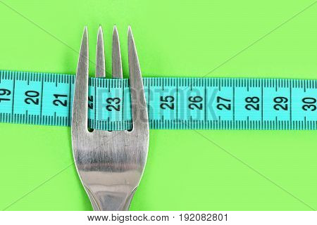 Tape For Measuring Focused On Number Twenty Three And Fork