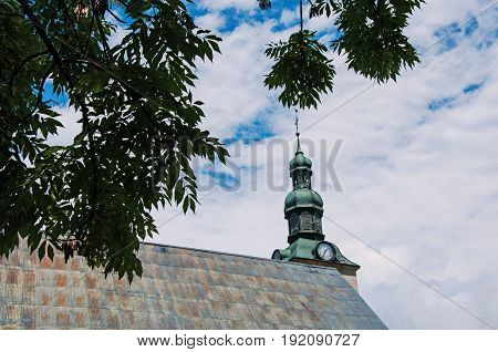 Megève, France - June 25, 2016. View of steeple with branches at the Saint Jean Baptiste' church in Megève, a famous ski resort located in Haute-Savoie Province, near the Mont Blanc in the French Alps