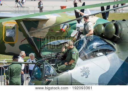 BERLIN GERMANY - JUNE 03 2016:Technicians inspect attack helicopter with transport capabilities Mil Mi-24 Hind. Czech Air Force. Exhibition ILA Berlin Air Show 2016