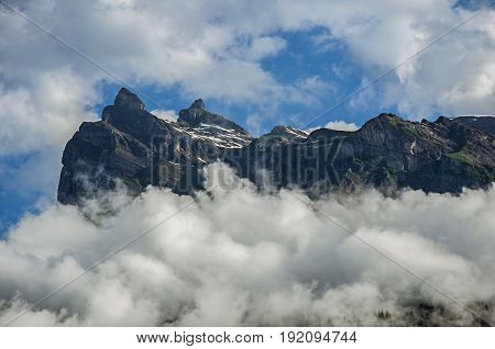 View of snowy peaks in Saint-Gervais-Les-Bains, French Alps, alpine mountains landscape, blue sky and clouds