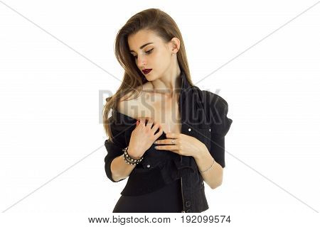 Young woman in black jacket without bra looking down isolated on white background