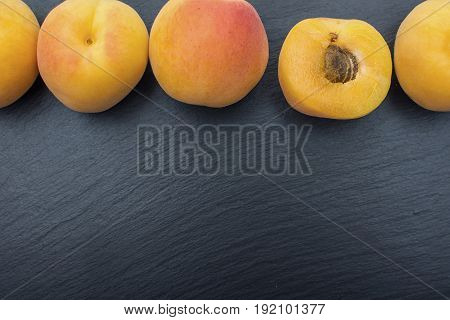 Ripe Apricot On Black Background Of Slate Or Stone