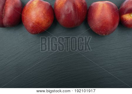 Ripe Nectarine On Black Background Of Slate Or Stone