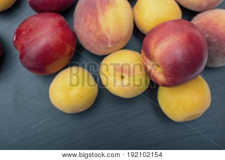 Ripe Apricot And Nectarine On Black Background Of Slate Or Stone