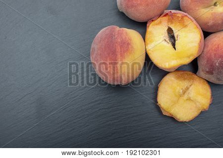Ripe Peach Ion Black Background Of Slate Or Stone