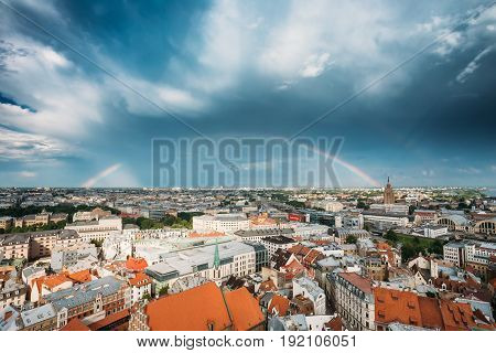 Riga, Latvia - July 1, 2016: Rainbow Over Cityscape. Building of Latvian Academy of Sciences, built on model of Moscow Stalin skyscrapers . Bureau and administration of Academy of Sciences, humanitarian institutions, Council for Science.