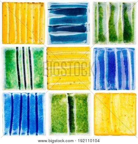 Collection of lined handmade glazed ceramic tiles isolated on white background
