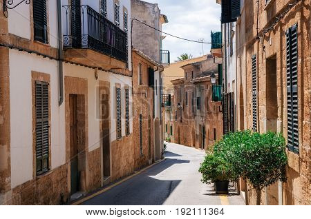 Narrow street of historical town part of Alcudia with its traditional house and architecture