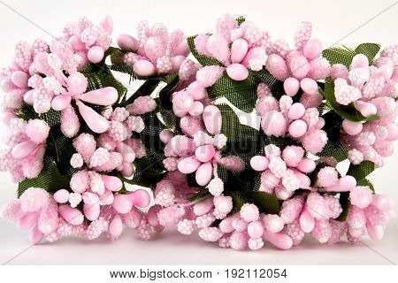 Closeup pink artificial flowers. Decoration in interior with pink blooms. Wedding attributes.
