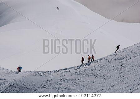View of climbers from the Aiguille du Midi, in French Alps Chamonix Mont Blanc, alpine mountains landscape, clear blue sky in warm sunny summer day