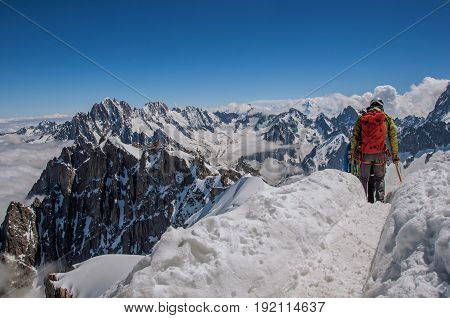 Climbers in french Alps Chamonix Mont Blanc, alpine mountains landscape, clear blue sky in warm sunny summer day