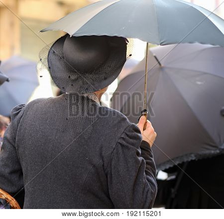 Elderly Lady With Vintage Clothes And A Black Umbrella With Vint