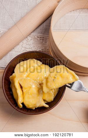 Close Up View Of Boiled Varenyky Or Dumpling With Cottage Cheese Or Curd On Metal Fork. Fresh Boiled