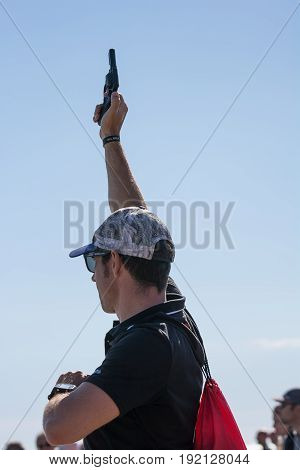Pescara Italy - June 18 2017: Man shoots with the starting pistol for the race of the Ironman 70.3 in Pescara on 18 June 2017