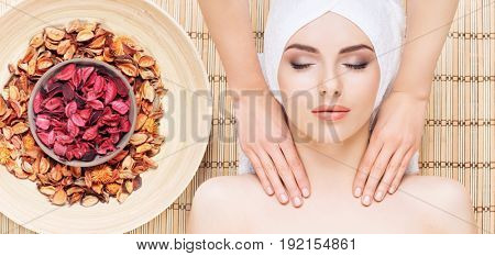 Healthy and beautiful girl getting spa treatment. Woman in spa salon over bamboo mat. Healing and oriental therapy concept.