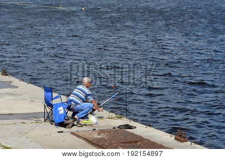 An unidentified person fishing.Modern residential area Obolon.June 21 ,2017 in Kiev, Ukraine