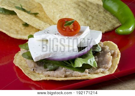 Mexican Tostada (tortilla toast) Panela cheese, cherry tomatos, coriander, salt and pepper