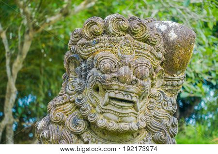 BALI, INDONESIA - MARCH 08, 2017: Close up of a beautiful stone statue inside of the Royal temple of Mengwi Empire located in Mengwi in Bali, Indonesia.