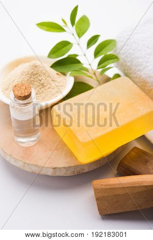 Ayurvedic handmade  Sandalwood both soap or chandan sabun with sandalwood sticks, ubtan or scrub or powder, oil and white towel, selective focus