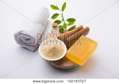 Ayurvedic handmade  Sandalwood both soap or chandan sabun with sandalwood sticks, ubtan or scrub or powder, oil and white towel, selective focus