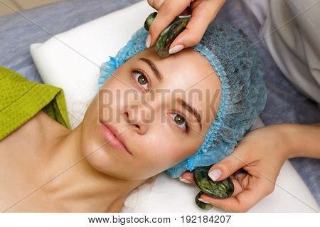 Spa treatment. Facial massage with jade stones. Alternative medicine. Massage of forehead zone. Guasha