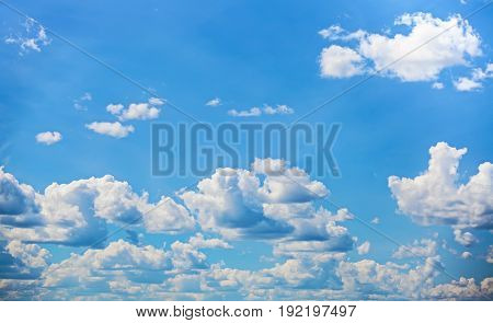 Azure sky with white clouds. Summer bottomless sky.