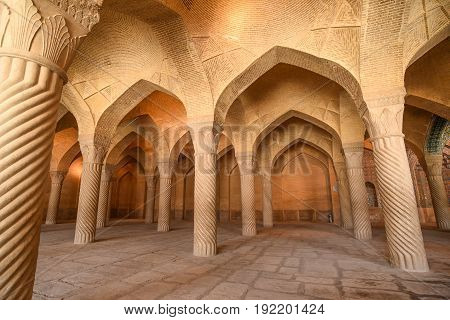Beautiful arch structure with spiral columns inside the prayer hall of Vakil Mosque in Shiraz Iran