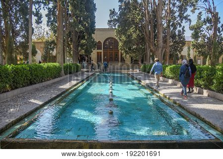 KASHAN IRAN - OCTOBER 21 2016 : Unidentified tourists walk in Fin Garden the historical Persian garden in Kashan Iran.