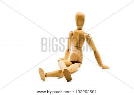 wooden man puppet sitting on white background