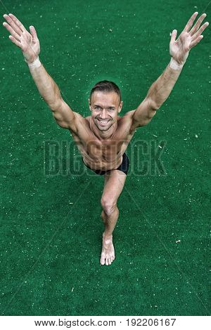 Man Yoga Practice Pose Training Concept athlete doing yoga asana at green background