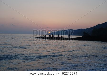 Sunset above mountains around sochi fisherfolk black see