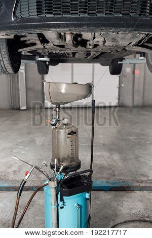 The image of tank for used crankcase oil. the car on the lift. can use to display or montage product or make a website for service