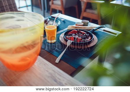 Mexican fajitos in a frying pan on a white table