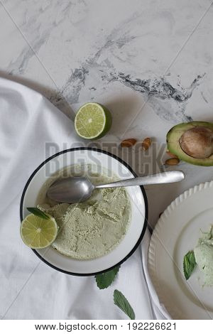 Beautiful composition with hand made tasty ice cream prepared with avocado and lime. Top view