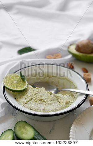 Beautiful composition with hand made tasty ice cream prepared with avocado and lime. Copy space for text