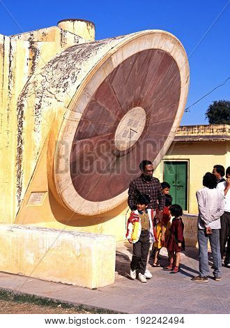 JAIPUR, INDIA - NOVEMBER 24, 1993 - People looking at the giant sundial known as the Samrat Yantra at Jantar Mantar Jai Singhs Observatory Jaipur Rajasthan India, November 24, 1993.