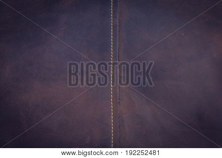Dark brown leather background and texture with middle line