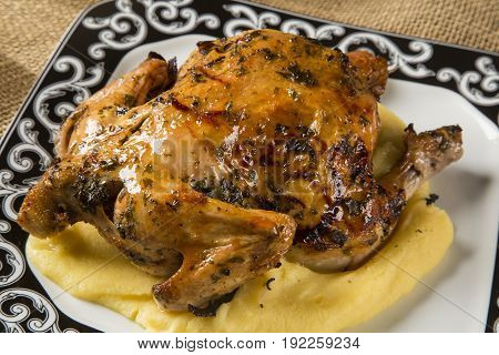 Little Chicken Dish With Polenta On Wood Background