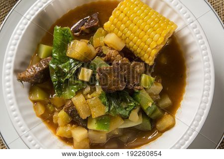 South American Cuisine: Puchero Soup With Chickpeas Close-up In A Pot On The Table.