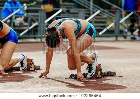Chelyabinsk Russia - June 4 2017: ready start female athlete sprinter run 100 meters during UrFO Championship in athletics
